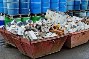Two large containers full of old batteries at a recycling centre