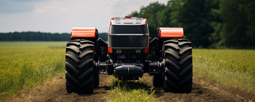 Autonomous tractor on a dirt road.