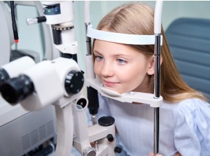A young girl having a pediatric eye exam at whelpley and paul