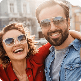 couple laughing wearing sunglasses
